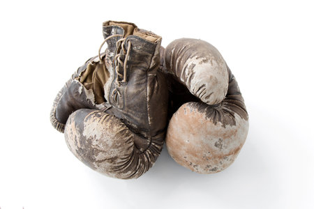 vintage worn leather brown boxing gloves isolated on white backgroundの写真素材