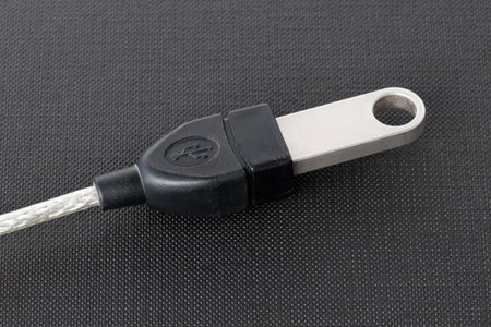 Flash memory drive plugged into a port usb cableの写真素材