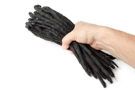 dreadlocks in hand, woven artificial kanekalon, for weaving into a hairstyle, close-up on a white isolated backgroundの写真素材