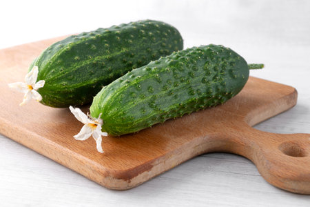 fresh cucumbers on the kitchen boardの写真素材
