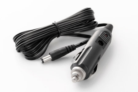 Car battery charger for mobile phones, laptops, isolated on white backgroundの写真素材