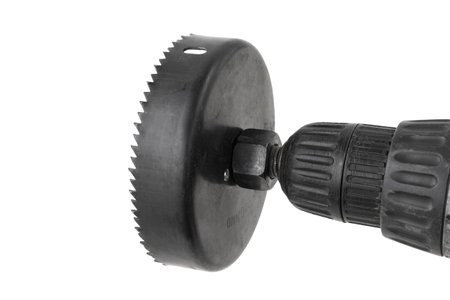 hole saw with attachment on an electric screwdriver, for drilling round holes in furniture or drywall, isolated, cut outの写真素材