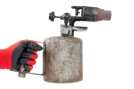 blowtorch in worker's hand, old, rusty, isolated on white backgroundの写真素材