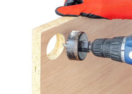 cutting a hole in the worktop with a hole saw with an electric screwdriver attachment, drilling round holes in furniture or drywall, isolated, cut outの写真素材