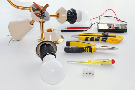 disassembled old chandelier and tool on white backgroundの写真素材