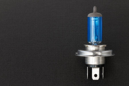 Halogen auto lamp, close-up of car headlight bulb on black backgroundの写真素材