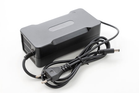 Electric bike charger, AC adapter on isolated white backgroundの写真素材