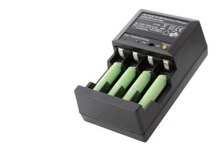 AAA batteries rechargeable in accumulator charger, isolated on a white backgroundの写真素材