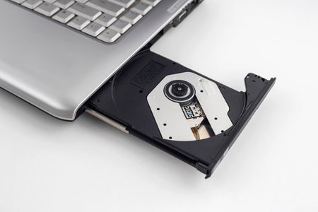 Laptop with open CD DVD drive, Closeup image isolated on a white background