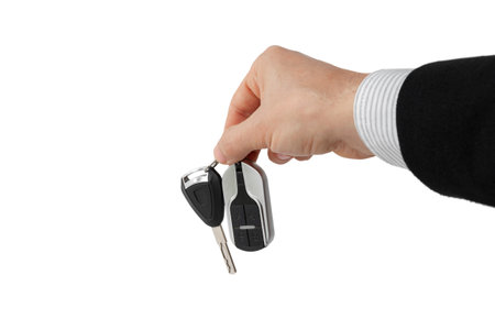Businessman holding car key isolated on whiteの写真素材
