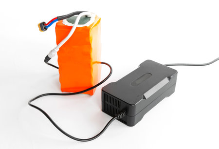 Charger connected to the Li-ion battery of an electric bicycle, the AC adapter charges the Li-ion battery pack.の写真素材