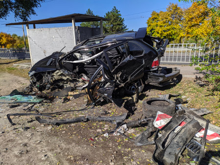 A wrecked car beyond repair thrown on the side of the roadの写真素材