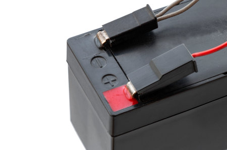 Acid rechargeable battery with wires connected to the pins, close-up, isolated on white backgroundの写真素材