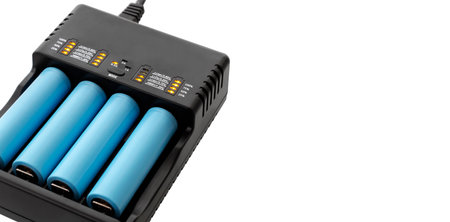 Charger with charge percentage and battery status indicator, 18650 lithium batteries inside, close-up, isolated background without shadow, cut out. With copy space.の写真素材