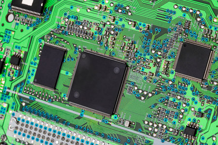 CD-ROM drive motherboard with green print and chip, close-upの写真素材