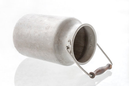 Vintage scratched milk churn, isolated on white backgroundの写真素材