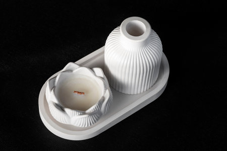 composition of white plaster flowerpots and candles, on black fabric, handmade conceptの写真素材