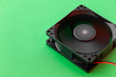 rotating vector computer fan, 12 volt, on green background. with copy spaceの写真素材