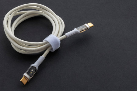 twisted universal USB type-c 100W cable with a modern connector for charging and synchronizing a...