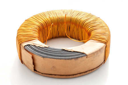 Electric transformer copper coil inductor on white background, close-upの写真素材