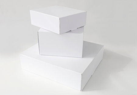 stacked white cardboard boxes on a white backgroundの写真素材