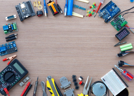 Top view of an electronics concept showing an Arduino UNO microcontroller with electronics configuration tools, with copy space for textの写真素材
