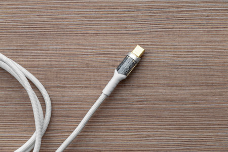 Top view of a USB Type C cable lying on a table. Close-up with space for text.の写真素材