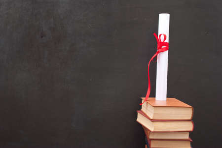 Chalkboard with a diploma and booksの写真素材