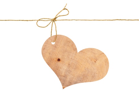 Wooden heart on a rope with a bowの写真素材