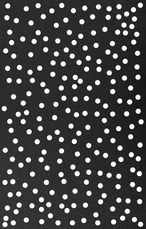 Abstract background of black paper with white dotsの写真素材