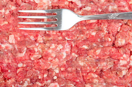 Fresh raw minced meat with forkの写真素材