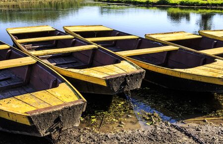 Boats anchored in a lake shore at natural resortの写真素材