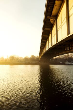 Bridge and river view from an interesting perspective with bright yellow shiningの写真素材