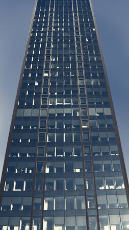 Building made of glass meets the skyの写真素材