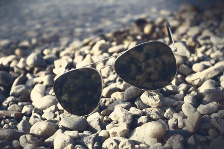 Sunglasses resting on the beachの写真素材