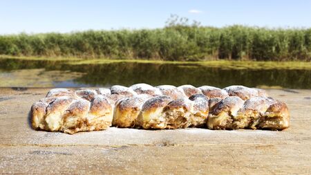 Strudel on a Wooden Table Resting All Sprinkeld With Shugar Powderの写真素材