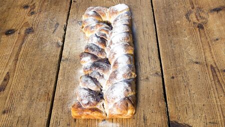 Strudel on a Wooden Table Resting All Srinkeld With Shugar Powder