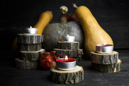 Happy Thanksgiving Day, Decoration on a wooden table with Burning Candles and  Pumpkins, Corncob, autumn leaves in the backgroundの写真素材