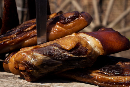 Smoked Bacon and Dried Sausages With Butcher's Knife On A Rustic Wooden Surface. Delicious Domestic Foodの写真素材