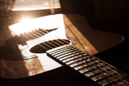 Acoustic Guitar In Music Studio Close up. Shined By The Sun At The Golden Hour