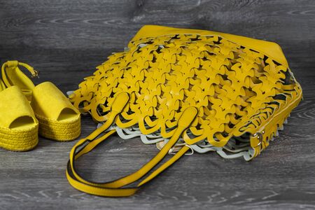 Woman's fashionable leather bag on a wooden surfaceの写真素材