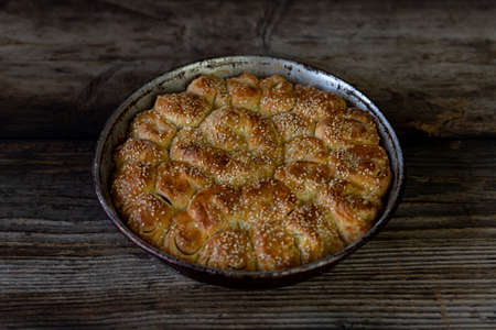Homemade baked bread on rustic wooden background