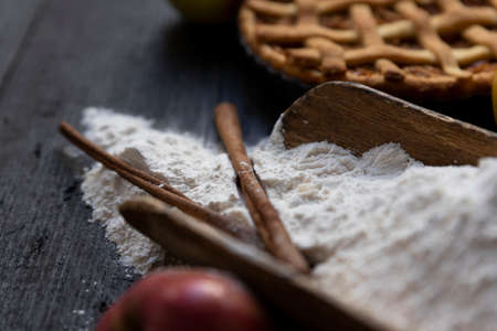 Homemade lattice Apple pie with cinnamon on an old textured wooden background