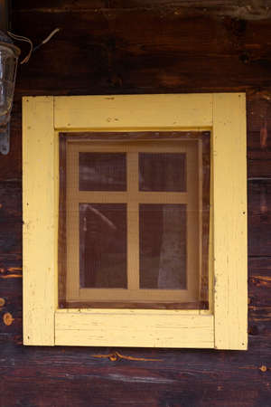 Vintage wooden window on a cabine with wooden boards around it