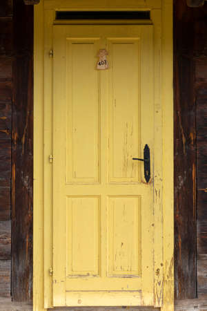 Vintage yellow cebine door at the wooden board wallの写真素材