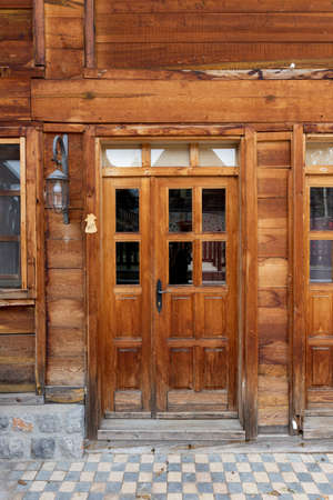 Wooden door on a old wooden cabine made of boardsの写真素材