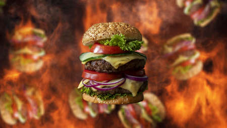 Hamburgers falling with smoke and burning fire in background. Fast food menu promoの写真素材