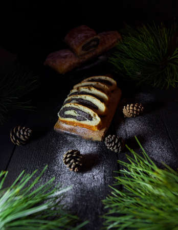 Poppy seed strudel on wooden rustic table. Traditional christmas strudel or Roll cakeの写真素材
