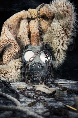 Military gas mask and rusty chain. Apocalyptic concept. Corona virus pandemic preventionの写真素材