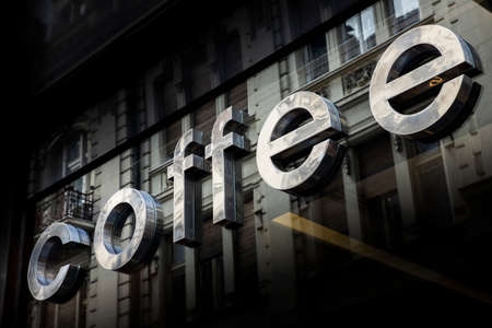Coffe shop sign against glass store windowの写真素材